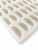 A close-up of a white silicone mold tray with multiple elongated, ribbed oval cavities, shown on a clean white background.