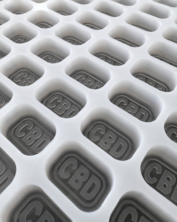 Close-up of 4mL brick gummy mold cavities with CBD imprint